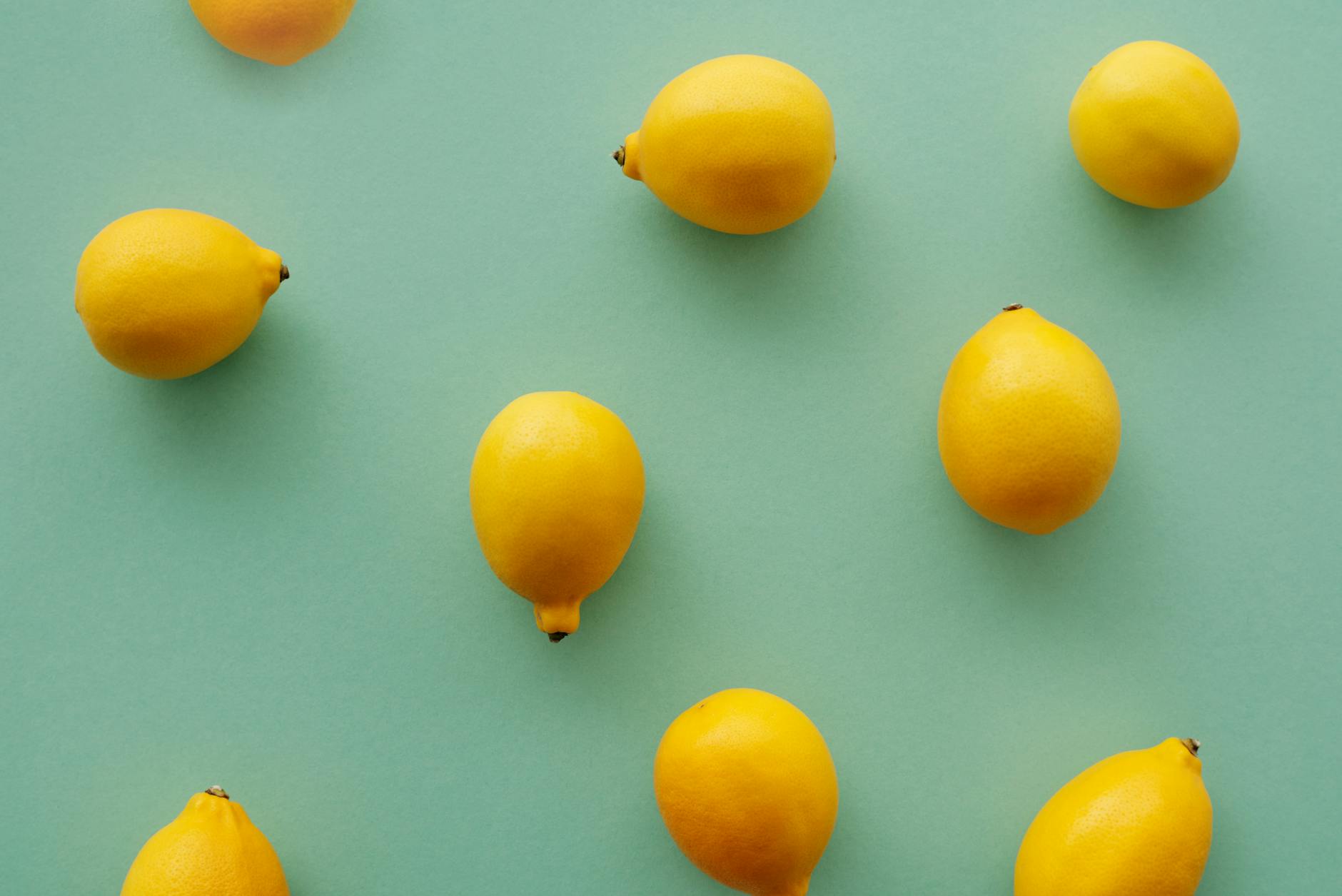 Fresh yellow lemons on a soft green background, symbolizing renewal and reconnection
