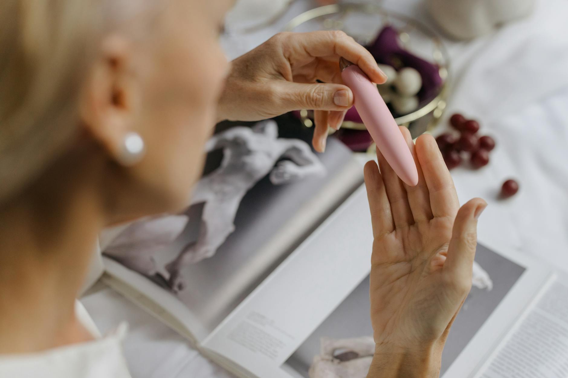 Hands holding pastel-colored silicone toys, representing intimate exploration during recovery.