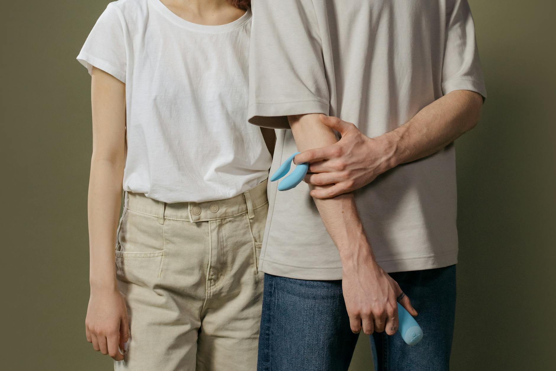 Hand holding a fresh lemon against a vivid yellow background, symbolizing renewed sensation and vitality