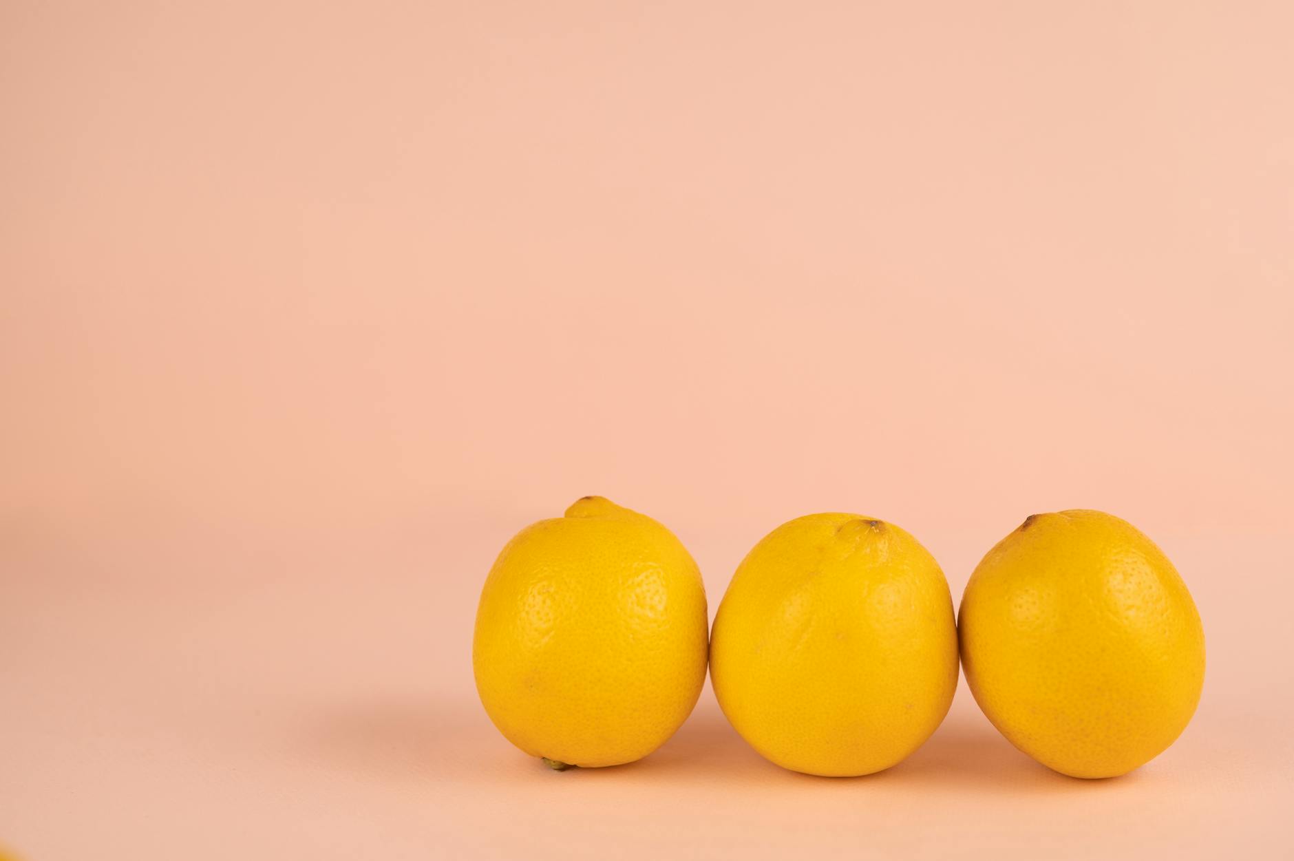 Bright ripe lemons on a pastel background, symbolizing fresh approaches to pleasure